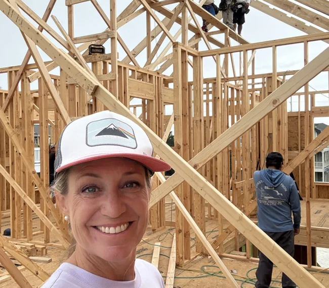 Kara Bolton taking a selfie with framing crew while they work on her residential build in the Outer Banks.